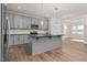 Spacious kitchen with gray cabinetry, a large island, stainless steel appliances, and hardwood floors at 75 Eltham, Rocky Mount, NC 27804