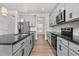 Modern kitchen with gray cabinets, black countertops, stainless steel appliances, and hardwood floors at 75 Eltham, Rocky Mount, NC 27804