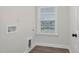 Laundry room with hardwood floors, a window, and hookups for a washer and dryer at 75 Eltham, Rocky Mount, NC 27804