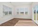 Bright sunroom featuring hardwood floors, large windows, and sliding door to the backyard at 75 Eltham, Rocky Mount, NC 27804