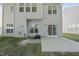 Backyard with a concrete patio and a well-kept lawn, ideal for outdoor enjoyment and entertaining at 7707 Oak Marsh Dr, Raleigh, NC 27616