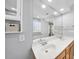 Bathroom featuring double sinks, wooden cabinets, large mirror, and tiled walls at 7707 Oak Marsh Dr, Raleigh, NC 27616