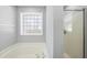 Bright, clean bathroom featuring a soaking tub and a shower with a glass door at 7707 Oak Marsh Dr, Raleigh, NC 27616