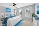 Bright bedroom with a ceiling fan, two windows, and light blue accents for a serene and relaxing space at 7707 Oak Marsh Dr, Raleigh, NC 27616
