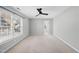 Neutral bedroom features a large window and doorway leading to other rooms at 7707 Oak Marsh Dr, Raleigh, NC 27616