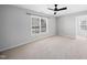 Sunlit bedroom featuring neutral paint, carpet, and a large window at 7707 Oak Marsh Dr, Raleigh, NC 27616