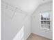Walk-in closet features neutral carpet, wire shelving, and a natural light filled window at 7707 Oak Marsh Dr, Raleigh, NC 27616