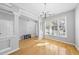 Bright dining room featuring beautiful hardwood floors, crown molding, a modern chandelier, and lots of natural light at 7707 Oak Marsh Dr, Raleigh, NC 27616