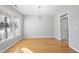 Bright dining room featuring beautiful hardwood floors, a modern chandelier, a large window, and neutral wall color at 7707 Oak Marsh Dr, Raleigh, NC 27616