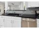 Kitchen featuring stainless steel appliances, black marble countertops, gray subway tile backsplash, and white cabinets at 7707 Oak Marsh Dr, Raleigh, NC 27616