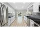 Spacious kitchen boasts white cabinetry, stainless appliances, tiled backsplash, and sliding glass doors to the backyard at 7707 Oak Marsh Dr, Raleigh, NC 27616
