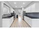 Spacious kitchen boasts white cabinetry, stainless appliances, tiled backsplash, and an open layout perfect for entertaining at 7707 Oak Marsh Dr, Raleigh, NC 27616