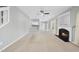 Spacious living room with fireplace, carpet, and open access to kitchen area at 7707 Oak Marsh Dr, Raleigh, NC 27616