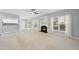 Bright and airy living room featuring a fireplace, large windows, and views to the outdoor space at 7707 Oak Marsh Dr, Raleigh, NC 27616