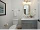 A stylish bathroom with a marble countertop, oval mirror, and classic fixtures at 8005 Woodcross Way, Wake Forest, NC 27587