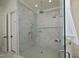 A modern bathroom featuring a glass-enclosed shower with dual shower heads and tiled walls at 8005 Woodcross Way, Wake Forest, NC 27587
