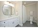 Stylish bathroom with white vanity and marble countertop, complemented by a modern mirror and gray tiled floors at 8005 Woodcross Way, Wake Forest, NC 27587