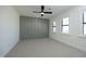 A well-lit bedroom featuring neutral carpet, board and batten wall detail, and large windows at 8005 Woodcross Way, Wake Forest, NC 27587