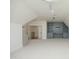 Open concept bonus room with neutral tones and built-in shelving for storage and decoration, featuring a ceiling fan at 8005 Woodcross Way, Wake Forest, NC 27587