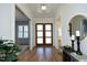 Bright foyer features wood floors, multi-lite doors, and view to other rooms at 8005 Woodcross Way, Wake Forest, NC 27587