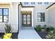 Inviting front entrance with a light-filled multi-lite door, complemented by well-maintained landscaping at 8005 Woodcross Way, Wake Forest, NC 27587