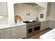 Modern kitchen boasts a stainless steel range, custom cabinetry, and stylish backsplash for cooking at 8005 Woodcross Way, Wake Forest, NC 27587