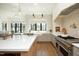 Elegant kitchen featuring a large island, stainless steel appliances, and decorative lighting for cooking and dining at 8005 Woodcross Way, Wake Forest, NC 27587