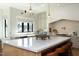 Bright kitchen features a large center island, stylish pendant lighting, and modern appliances for cooking at 8005 Woodcross Way, Wake Forest, NC 27587