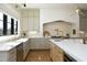 Well-lit kitchen showcases a farmhouse sink, stainless steel appliances, and ample counter space for cooking at 8005 Woodcross Way, Wake Forest, NC 27587