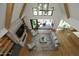 Aerial view of a well-lit living room with a stone fireplace, comfortable seating, and open access to a porch at 8005 Woodcross Way, Wake Forest, NC 27587