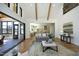 Bright open-concept living room featuring wood floors, high ceilings, and seamless access to the outdoor porch at 8005 Woodcross Way, Wake Forest, NC 27587