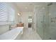 A luxurious main bathroom with a soaking tub, walk-in shower, and stylish vanity provides a spa-like experience at 8005 Woodcross Way, Wake Forest, NC 27587