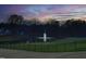 Scenic pond view with a fountain, surrounded by mature trees and manicured landscaping at 8005 Woodcross Way, Wake Forest, NC 27587