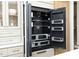 A built-in refrigerator with sleek black interior, adjustable shelving, and crisper drawers offers modern convenience at 8005 Woodcross Way, Wake Forest, NC 27587