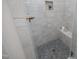 Detailed shot of a walk-in shower with gray tiled walls, mosaic tile floors, and built-in bench at 8005 Woodcross Way, Wake Forest, NC 27587