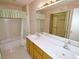 Bathroom features double sinks, a shower/tub, and vanity at 8008 Grey Oak Dr, Raleigh, NC 27615
