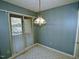 This dining area features a pendant light fixture and sliding glass doors at 8008 Grey Oak Dr, Raleigh, NC 27615