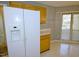 Bright kitchen features a side-by-side refrigerator, wood cabinets, and sliding glass doors at 8008 Grey Oak Dr, Raleigh, NC 27615