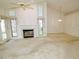 Spacious living room with a fireplace, large windows, and plenty of natural light at 8008 Grey Oak Dr, Raleigh, NC 27615