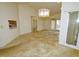 Open living room with light carpet, chandelier and access to a backyard patio at 8008 Grey Oak Dr, Raleigh, NC 27615