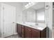Bright bathroom featuring double sink vanity, large mirror, and neutral paint at 808 Cross Link Dr, Angier, NC 27501