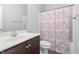 Bathroom features a single sink vanity, toilet, and shower with cherry blossom curtain at 808 Cross Link Dr, Angier, NC 27501