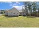 Rear view of home with deck overlooking large grassy yard at 808 Cross Link Dr, Angier, NC 27501