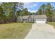 Charming home with stone accents, gray siding, a manicured lawn, and an attached two car garage at 808 Cross Link Dr, Angier, NC 27501