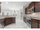 Modern kitchen with stainless steel appliances, granite countertops, dark wood cabinets, and a breakfast bar at 808 Cross Link Dr, Angier, NC 27501