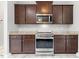Kitchen featuring dark wood cabinets, stainless steel appliances, and granite countertops at 808 Cross Link Dr, Angier, NC 27501