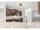 Modern kitchen with granite countertops, stainless steel appliances, and dark wood cabinetry at 808 Cross Link Dr, Angier, NC 27501