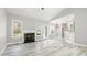 Open-concept living room featuring a fireplace, modern flooring, and access to the kitchen at 808 Cross Link Dr, Angier, NC 27501