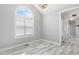 Bright living room featuring a large arched window, sleek marble flooring, and modern lighting at 808 Cross Link Dr, Angier, NC 27501