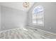 Bright, airy living room featuring a vaulted ceiling, modern lighting, and sleek marble flooring at 808 Cross Link Dr, Angier, NC 27501